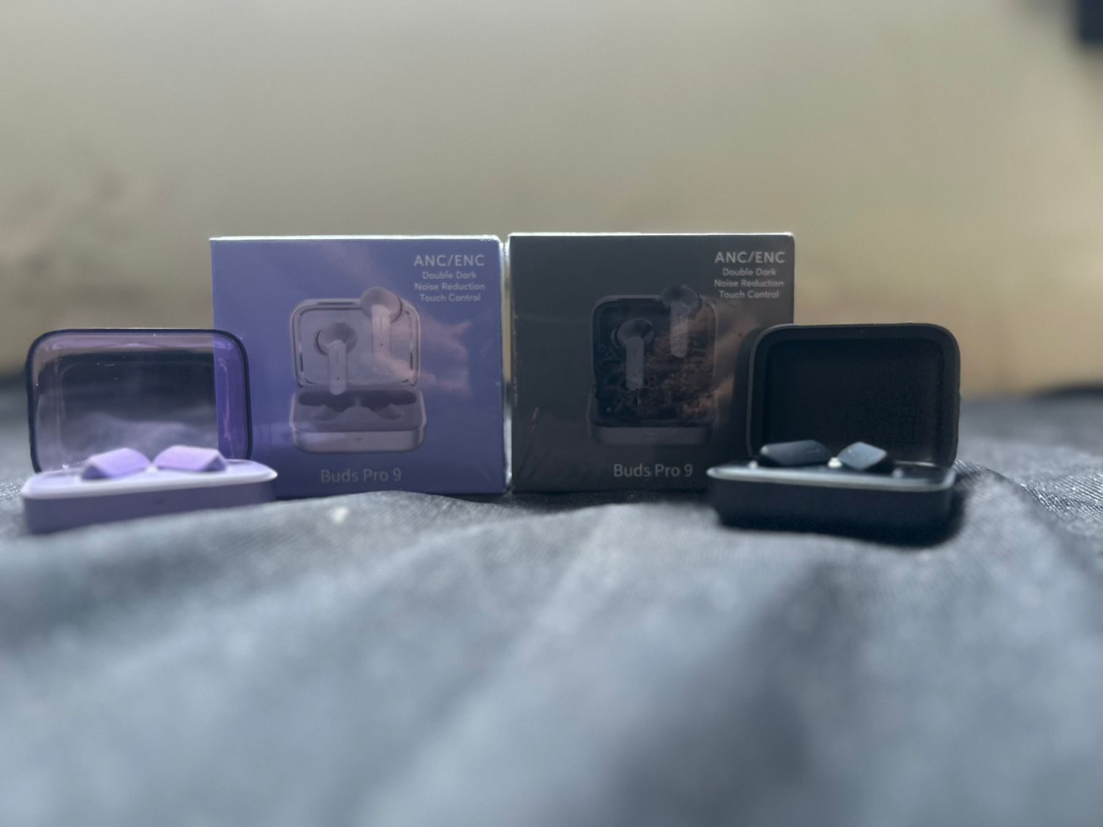 Buds Pro 9 Lavender Purple earbuds held in hand outdoors