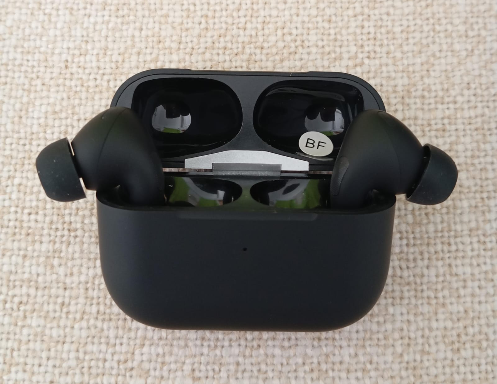 Black Pro 2 earbuds with charging case front view