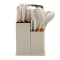 Cream kitchen utensil and knife set arranged in a storage organizer