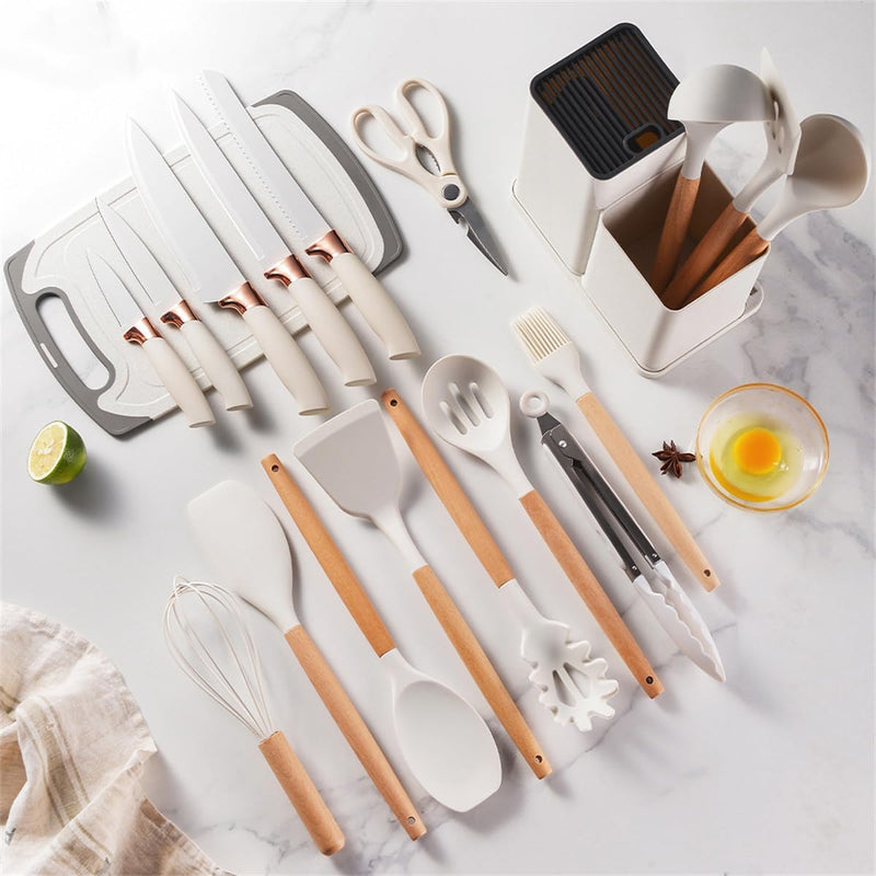 Kitchen knives, utensils, cutting board and scissors laid out with organizer