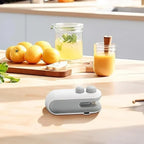 Compact grey and white portable bag heat sealer on a kitchen counter