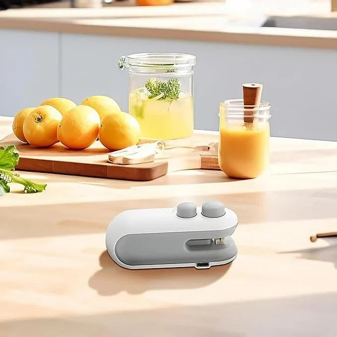 Compact grey and white portable bag heat sealer on a kitchen counter